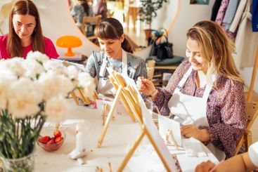 Young women in casual clothes at a painting workshop