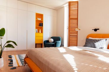 Modern stylish interior of bedroom with bright accents...