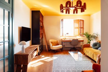 Modern living room with wooden furniture. Bright sunlight