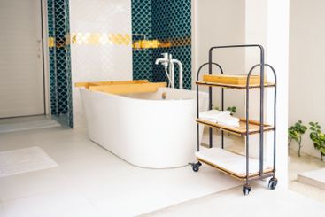 Stylish mobile shelf with clean towels in the bathroom....