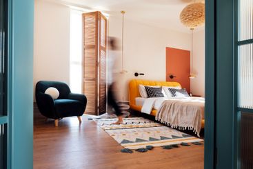 A cozy bedroom with white walls. An open stylish blue...