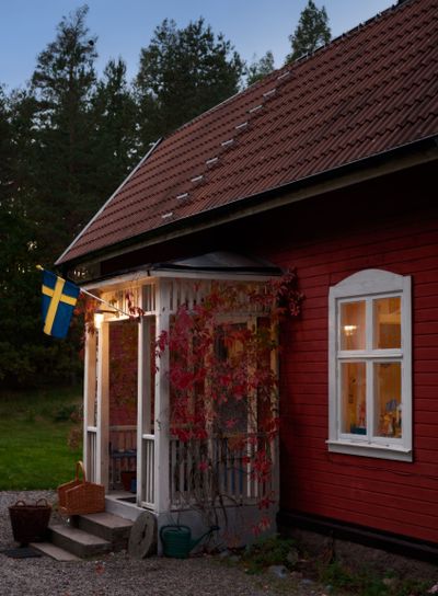 Red wooden cottage in Sweden in the evening