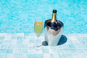 Glass and ice bucket with champagne on the side of the...