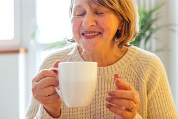 Close-up of an elderly woman in a knitted sweater...