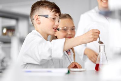kids with test tube studying chemistry at school