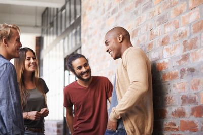 Talking, laughing and college friends or students in a...