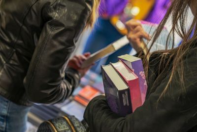 Close-up of girl hands with books, bookstore. Education,...