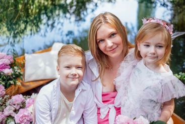 Beautiful young woman and her blonde cute children in...