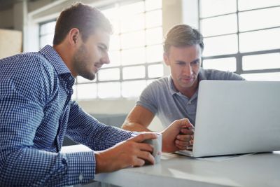 Office laptop, reading and business people review...