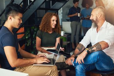 Startup, laptop or designers talking in meeting in...