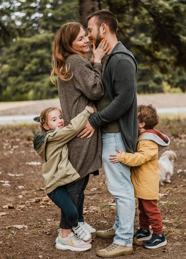 full shot happy family hugging