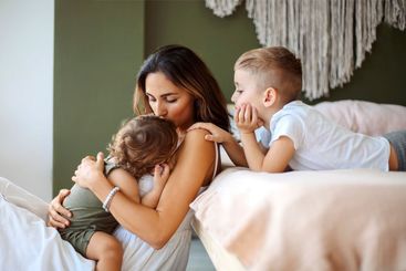 Young family beautiful mother with two son of different...