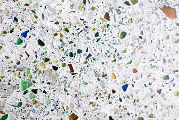 Granite texture with colorful pebbles. Bright glasses on...
